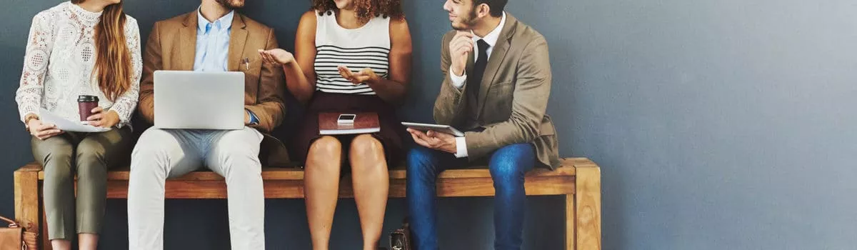 4 seated people discussing 