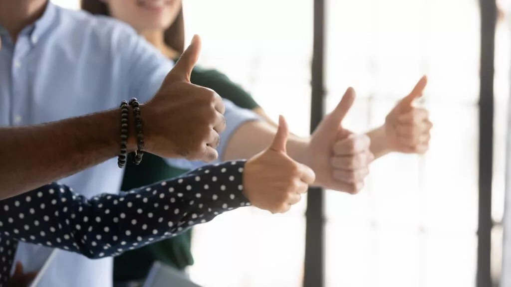 4 people giving a thumbs up