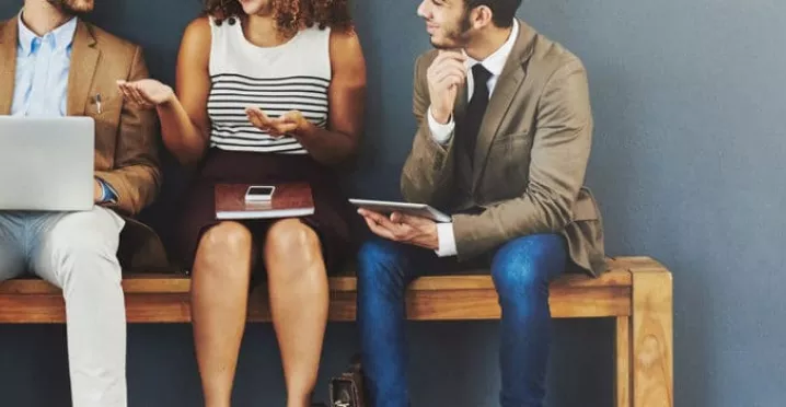 4 seated people discussing