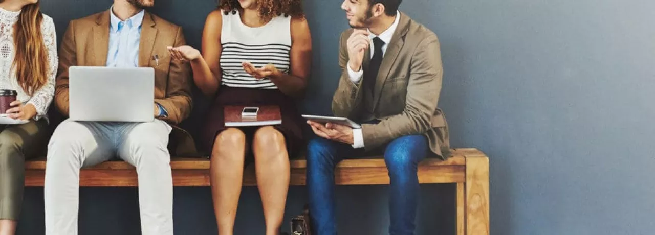 4 seated people discussing