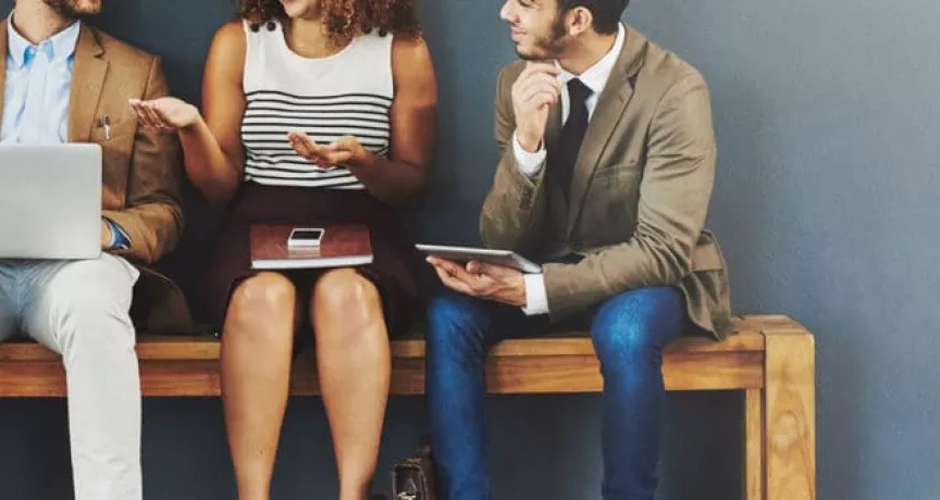 4 seated people discussing