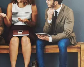 4 seated people discussing