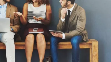 4 seated people discussing