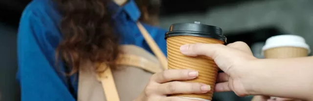 Barista handing over coffee